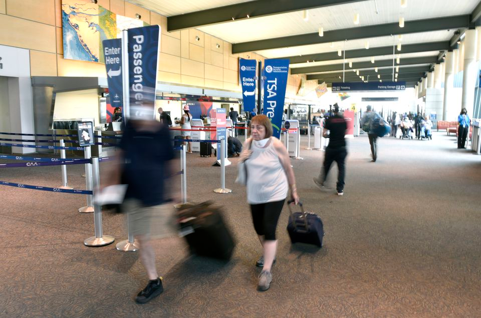 Passengers move through Bradley International Airport, Thursday, June 30, 2022.