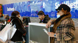 Denise Simon Mattei, left, checks bags for herself and Elaine Simon's , right, journey back to Baltimore with a Southwest Airlines agent at Dallas Love Field Airport on Dec. 27, 2022.