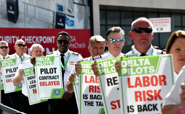 Delta pilots conduct informational picketing at the south terminal at Hartsfield-Jackson Atlanta International Airport ahead of the busy Labor Day travel weekend as they push for a new labor contract on Sept. 1, 2022.