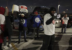 Steven Everett yells into a megaphone during a protest by ride-share drivers at a lot near O'Hare International Airport on Dec. 27, 2022. Drivers held a rally to bring attention to wage issues and deactivations without review. Steven Everett yells into a megaphone during a protest by ride-share drivers at a lot near O'Hare International Airport on Dec. 27, 2022. Drivers held a rally to bring attention to wage issues and deactivations without review.