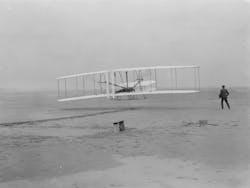 Orville Wright takes off in the first flight of the 1903 flyer as Wilbur Wright assists. Orville Wright takes off in the first flight of the 1903 flyer as Wilbur Wright assists.