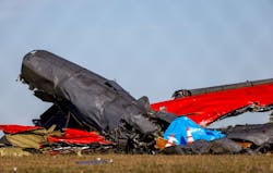 A damaged plane remains in the open field at the Dallas Executive Airport on Sunday, Nov. 13, 2022, after a Boeing B-17 Flying Fortress and a Bell P-63 Kingcobra crashed a day earlier.
