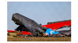 A damaged plane remains in the open field at the Dallas Executive Airport on Sunday, Nov. 13, 2022, after a Boeing B-17 Flying Fortress and a Bell P-63 Kingcobra crashed a day earlier.