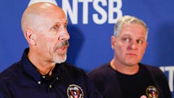National Transportation Safety Board member Michael Graham (left) answers questions as senior air safety investigator Jason Aguilera listens during a press conference about the NTSB s investigation into the airshow plane collision at the Dallas Executive Airport Terminal in November.