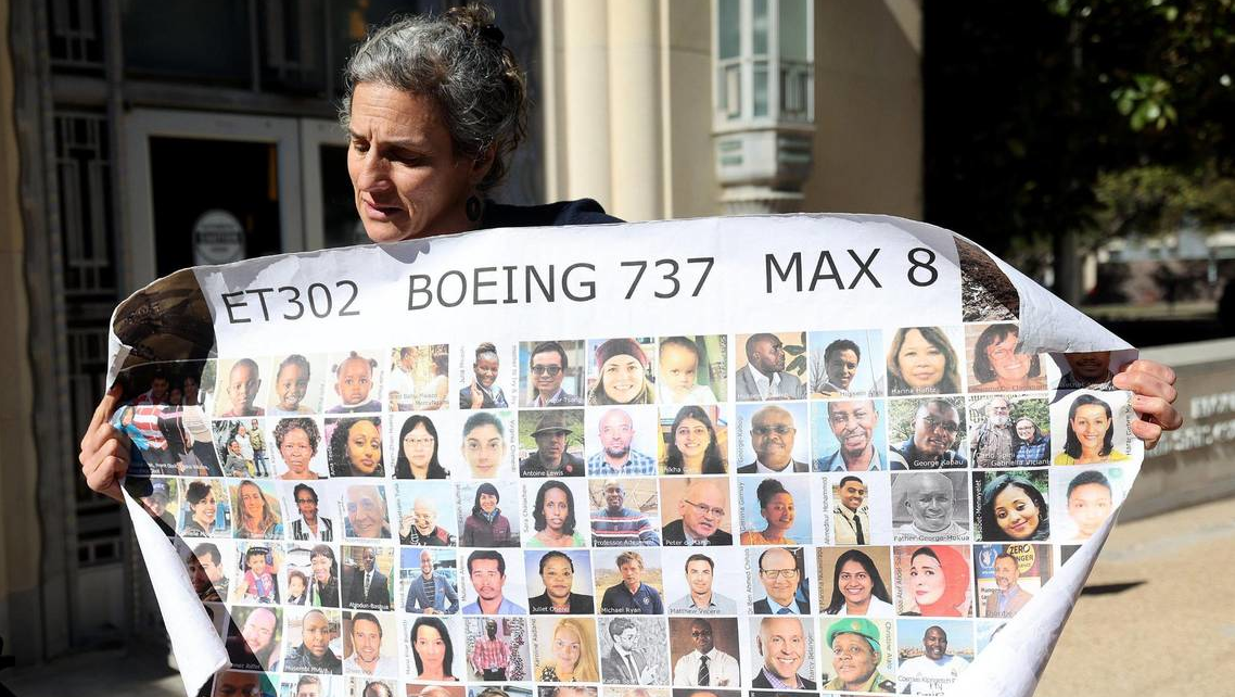 Nadia Millerson, the mother of Samya Stumo who was killed in one of the two plane crashes involving a Boeing 737 MAX, unfurls a banner with photographs of some of the victims following an arraignment at the federal courthouse in Fort Worth on Thursday, January 26, 2023, at the federal court in Fort Worth. She and other family members attended an arraignment challenging the plea agreement Boeing made with the Justice Department that granted them immunity from criminal prosecution.