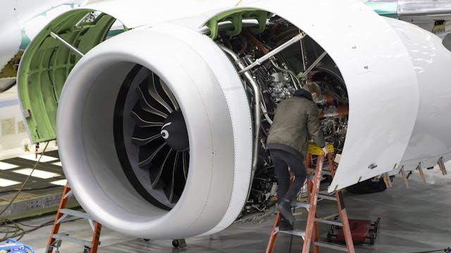 A Boeing employee works on the engine of a 737 MAX on the final assembly line at Boeing&rsquo;s Renton plant in June. About 40% of the 374 MAX deliveries in 2022 were of jets taken out of long-term storage and reworked. About 230 rolled out new from the Renton assembly line.