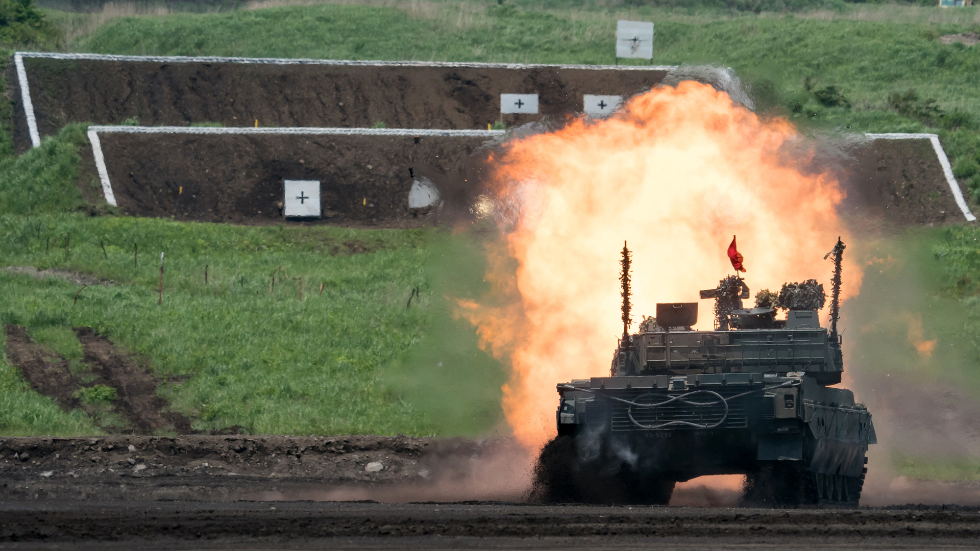 A Japan Ground Self-Defense Force (JGSDF) Type 10 battle tank fires ammunition during a live fire exercise at East Fuji Maneuver Area in Gotemba on May 28, 2022.