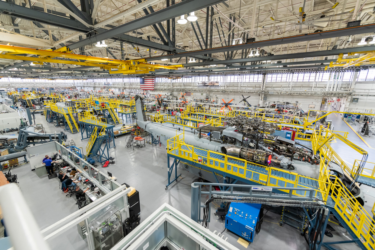 Sikorsky employees building CH-53K aircraft utilizing 3-D work instructions, new titanium machining centers with multi-floor ergonomic platforms.