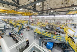 Sikorsky employees building CH-53K aircraft utilizing 3-D work instructions, new titanium machining centers with multi-floor ergonomic platforms.