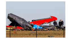 Officials, including those from the Federal Aviation Administration, survey damage from a Boeing B-17 Flying Fortress and a Bell P-63 Kingcobra crash a day earlier at the Dallas Executive Airport on Sunday, Nov. 13, 2022.