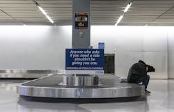 A homeless person sleeps inside Terminal 2 baggage claim on Jan. 19, 2023, at O Hare International Airport. A homeless person sleeps inside Terminal 2 baggage claim on Jan. 19, 2023, at O Hare International Airport.