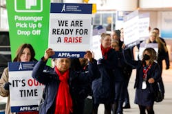 American Airlines flight attendants and members of the Association of Professional Flight Attendants picket over stalled contract negotiations on Tuesday, Jan. 24, 2023, outside of Terminal D at DFW International Airport.