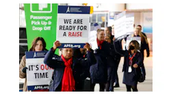 American Airlines flight attendants and members of the Association of Professional Flight Attendants picket over stalled contract negotiations on Tuesday, Jan. 24, 2023, outside of Terminal D at DFW International Airport.