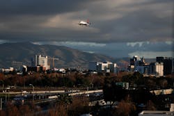 SAN JOSE, CALIFORNIA - DECEMBER 8: An airplane flies over downtown San Jose, Calif., into the the Mineta San Jose Airport on Sunday, Dec. 8, 2019.
