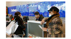 Denise Simon Mattei, left, checks bags for herself and Elaine Simon's , right, journey back to Baltimore with a Southwest Airlines agent at Dallas Love Field Airport on Dec. 27, 2022.