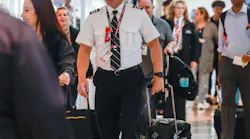Southwest Airlines pilot Elden L. Hampton Jr. walks surrounded by travelers at the Dallas Love Field in Dallas on Thursday, Jan. 19, 2023.