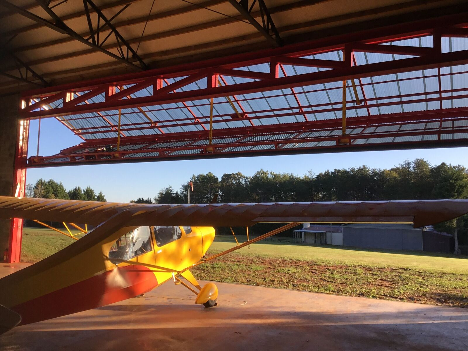 Nick and Michelle Cwian of Easley, S.C., are enjoying their new 60-foot by 70-foot hangar at Williamsport Airpark. It has a 50-foot by 16-foot Schweiss Doors bifold liftstrap door. Here, their Aeronca Champ is ready to leave the hangar. They also have an Aeronca Chief.