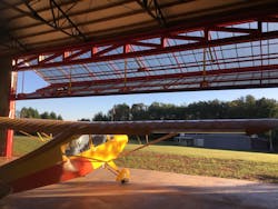 Nick and Michelle Cwian of Easley, S.C., are enjoying their new 60-foot by 70-foot hangar at Williamsport Airpark. It has a 50-foot by 16-foot Schweiss Doors bifold liftstrap door. Here, their Aeronca Champ is ready to leave the hangar. They also have an Aeronca Chief.