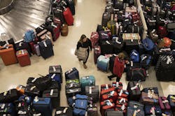 Madison Hranka, of Chicago, searches for her luggage among the hundreds of bags separated from their owners by major Southwest Airlines service interruptions at Midway Airport on Dec. 27, 2022, in Chicago. Madison Hranka, of Chicago, searches for her luggage among the hundreds of bags separated from their owners by major Southwest Airlines service interruptions at Midway Airport on Dec. 27, 2022, in Chicago.