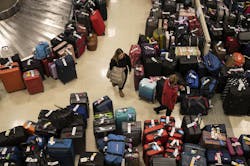 Madison Hranka, of Chicago, searches for her luggage among the hundreds of bags separated from their owners by major Southwest Airlines service interruptions at Midway Airport on Dec. 27, 2022, in Chicago.