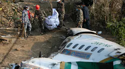 Nepal army, police and rescuers recover the body of a victim who died in a Yeti Airlines plane crash in Pokhara, Monday, Jan. 16, 2023.