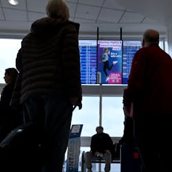 Travelers look at the arrivals and departures monitors at Ontario International Airport in Ontario on Wednesday, Jan. 11, 2023. Air travel has nearly rebounded from the COVID-19 pandemic slump, though concerns over climate impacts are keeping some travelers grounded.