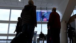 Travelers look at the arrivals and departures monitors at Ontario International Airport in Ontario on Wednesday, Jan. 11, 2023. Air travel has nearly rebounded from the COVID-19 pandemic slump, though concerns over climate impacts are keeping some travelers grounded.