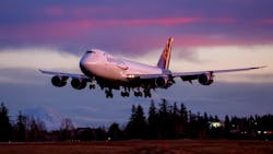 The sun sets on an era of aviation manufacturing as the very last Boeing 747 lands at Paine Field following a test flight, Tuesday, Jan. 10, 2023 in Everett, Washington.