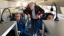 Marty Ralph, center, watches as meteorologists Rich Henning, left, and Sofia de Solo track data while flying above an atmospheric river over the Pacific Ocean. Marty Ralph, center, watches as meteorologists Rich Henning, left, and Sofia de Solo track data while flying above an atmospheric river over the Pacific Ocean.
