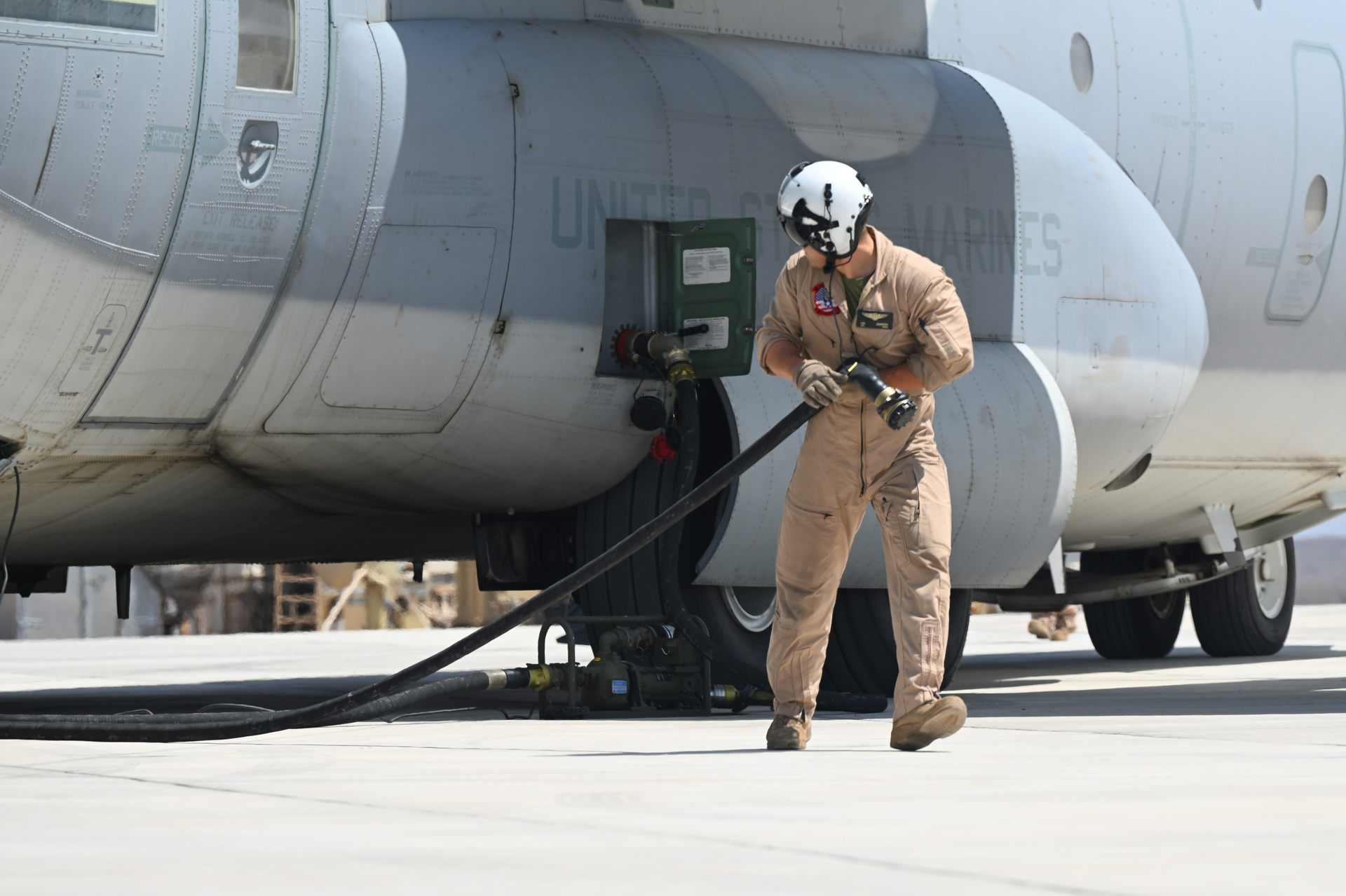 A U.S. Marine Corps KC-130J Super Hercules crew member prepares to conduct a refueling operation in support of a simulated Forward Arming and Refueling Point exercise at Chabelley Airfield, Djibouti, Feb. 22, 2023. The FARP mission enables aircraft supporting combat operations to refuel much closer to their area of operation, saving a significant amount of time.