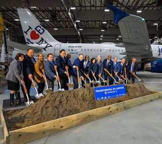 New York Governor Kathy Hochul (seventh from right) and JetBlue CEO Robin Hayes (first right) join leaders for the JFK Terminal 6 groundbreaking.
