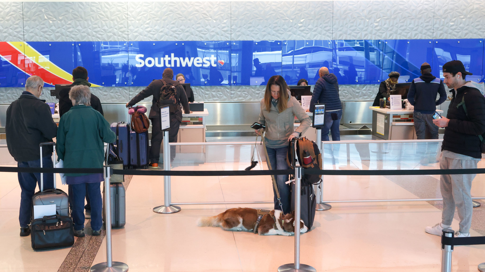 Travelers wait in line to speak with Southwest Airlines agents at the airline s ticket counter at Dallas Love Field Airport in Dallas on Wednesday, Feb. 1, 2023. Two-thirds of planned departures from all airlines at the airport were called off on Wednesday, according to flight tracking site Flightaware.com.