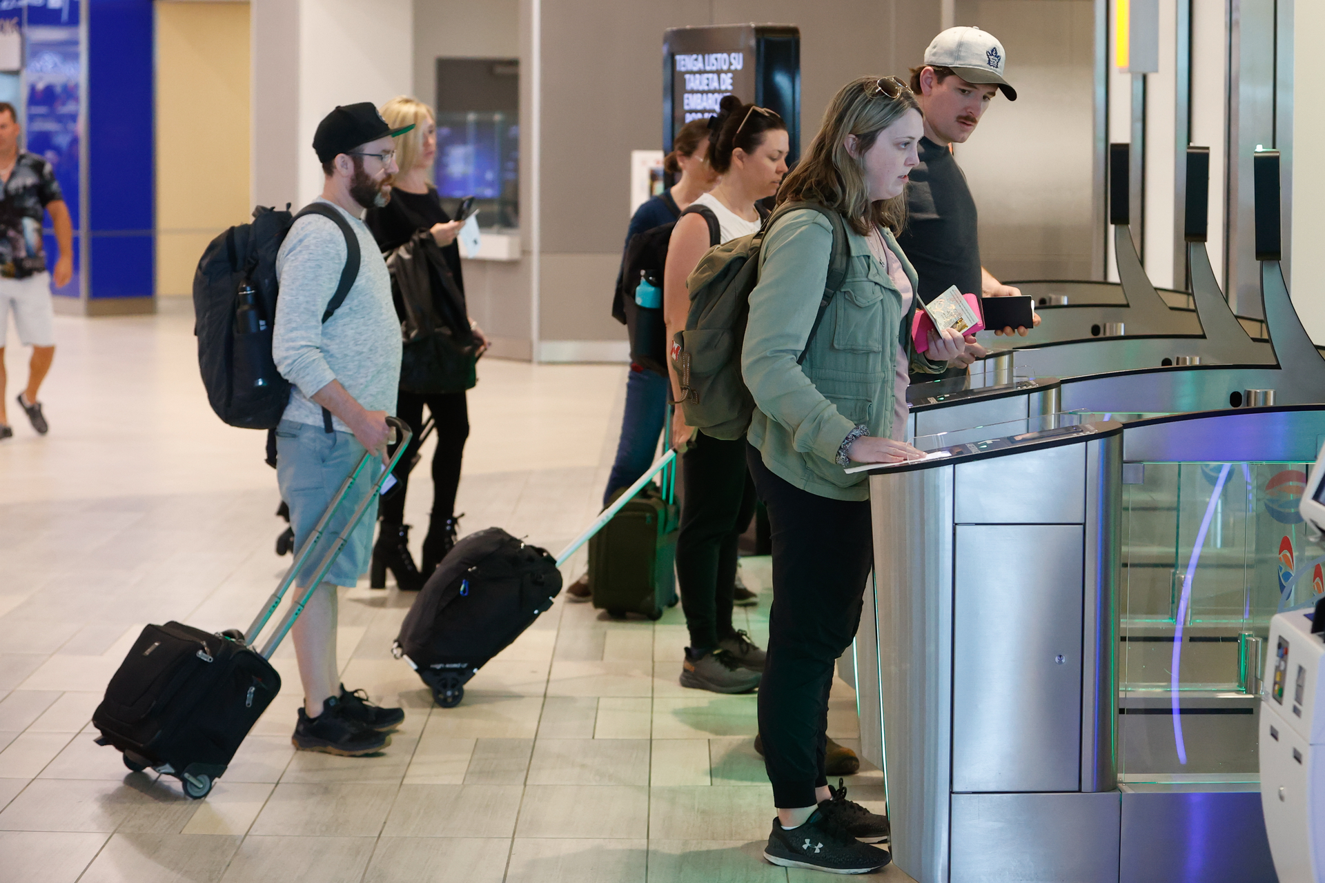 Passengers go through security gates to board the tram to their gate at Tampa International Airport on Thursday, March 9, 2023, in Tampa.