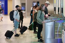 Passengers go through security gates to board the tram to their gate at Tampa International Airport on Thursday, March 9, 2023, in Tampa.