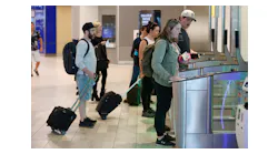 Passengers go through security gates to board the tram to their gate at Tampa International Airport on Thursday, March 9, 2023, in Tampa.