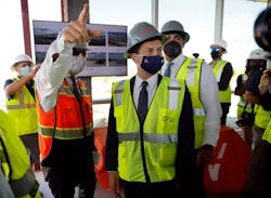 DFW Airport Executive Vice President of Infrastructure and Development Khaled Naja (left) points out construction features to U.S. Transportation Secretary Pete Buttigieg (right) as they tour building sections of the new Terminal C remodel at DFW International Airport. He came to see and hear how the Bipartisan Infrastructure Deal s investments in jobs,?airports and transit will benefit the area, Wednesday, August 11, 2021.
