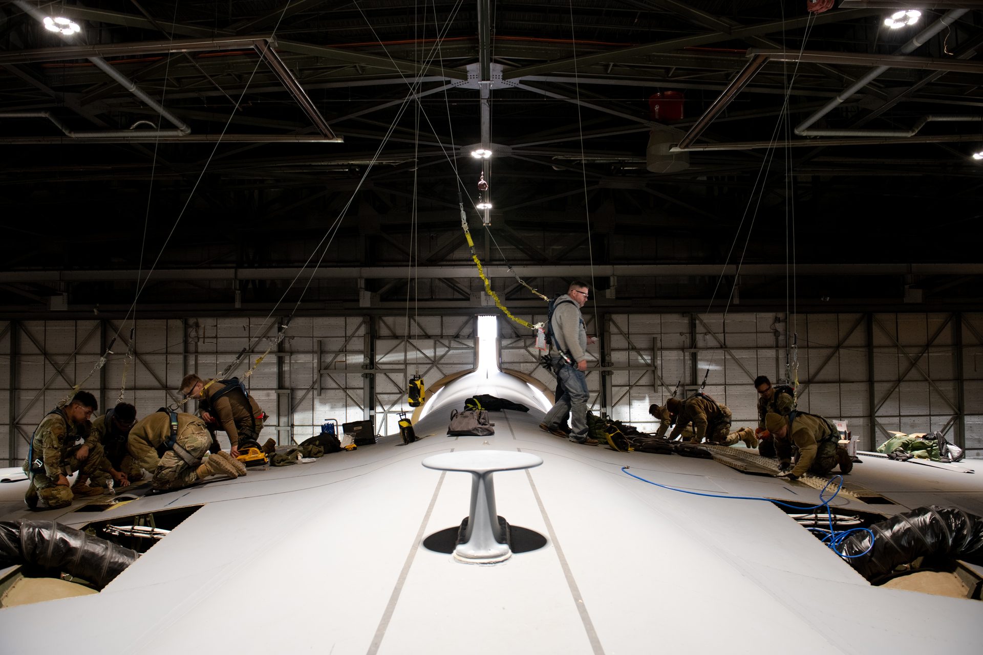 Airmen from the 60th Maintenance Squadron and 349th Maintenance Squadron prepare the wing surface of a C-5M Super Galaxy prior to maintenance at Travis Air Force Base, Calif., Jan. 31, 2023. Maintainers modified an aerodynamic fairing over a wing splice of a C-5M Super Galaxy incorporating newly printed 3D parts known as blocks and wedges.