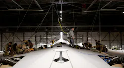 Airmen from the 60th Maintenance Squadron and 349th Maintenance Squadron prepare the wing surface of a C-5M Super Galaxy prior to maintenance at Travis Air Force Base, Calif., Jan. 31, 2023. Maintainers modified an aerodynamic fairing over a wing splice of a C-5M Super Galaxy incorporating newly printed 3D parts known as blocks and wedges.