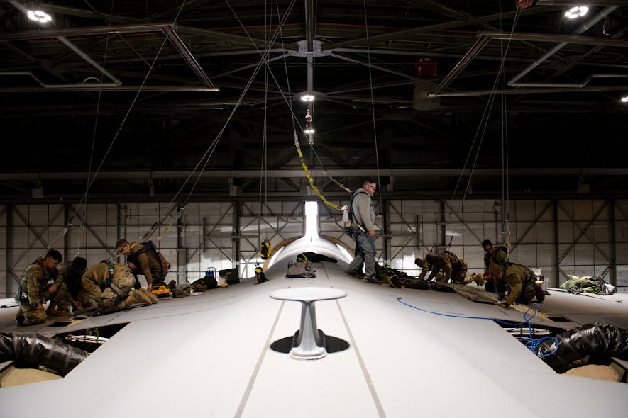 Airmen from the 60th Maintenance Squadron and 349th Maintenance Squadron prepare the wing surface of a C-5M Super Galaxy prior to maintenance at Travis Air Force Base, Calif., Jan. 31, 2023. Maintainers modified an aerodynamic fairing over a wing splice of a C-5M Super Galaxy incorporating newly printed 3D parts known as blocks and wedges.