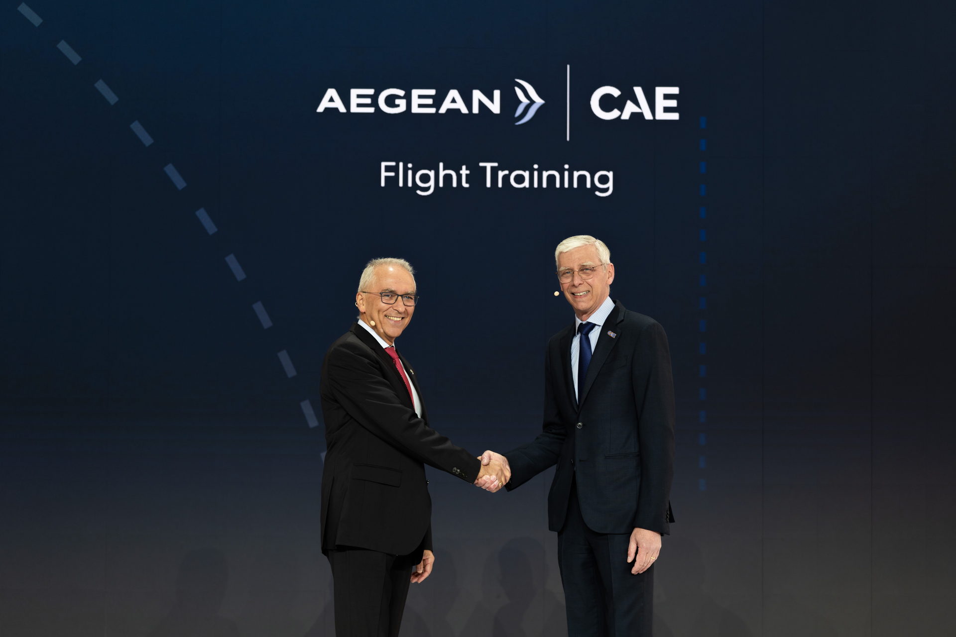 AEGEAN&rsquo;s CEO Dimitrios Gerogiannis and CAE&rsquo;s Group President, Civil Aviation, Nick Leontidis shake hands at an event to announce a joint venture between AEGEAN and CAE to open a new training center in Athens, Greece.