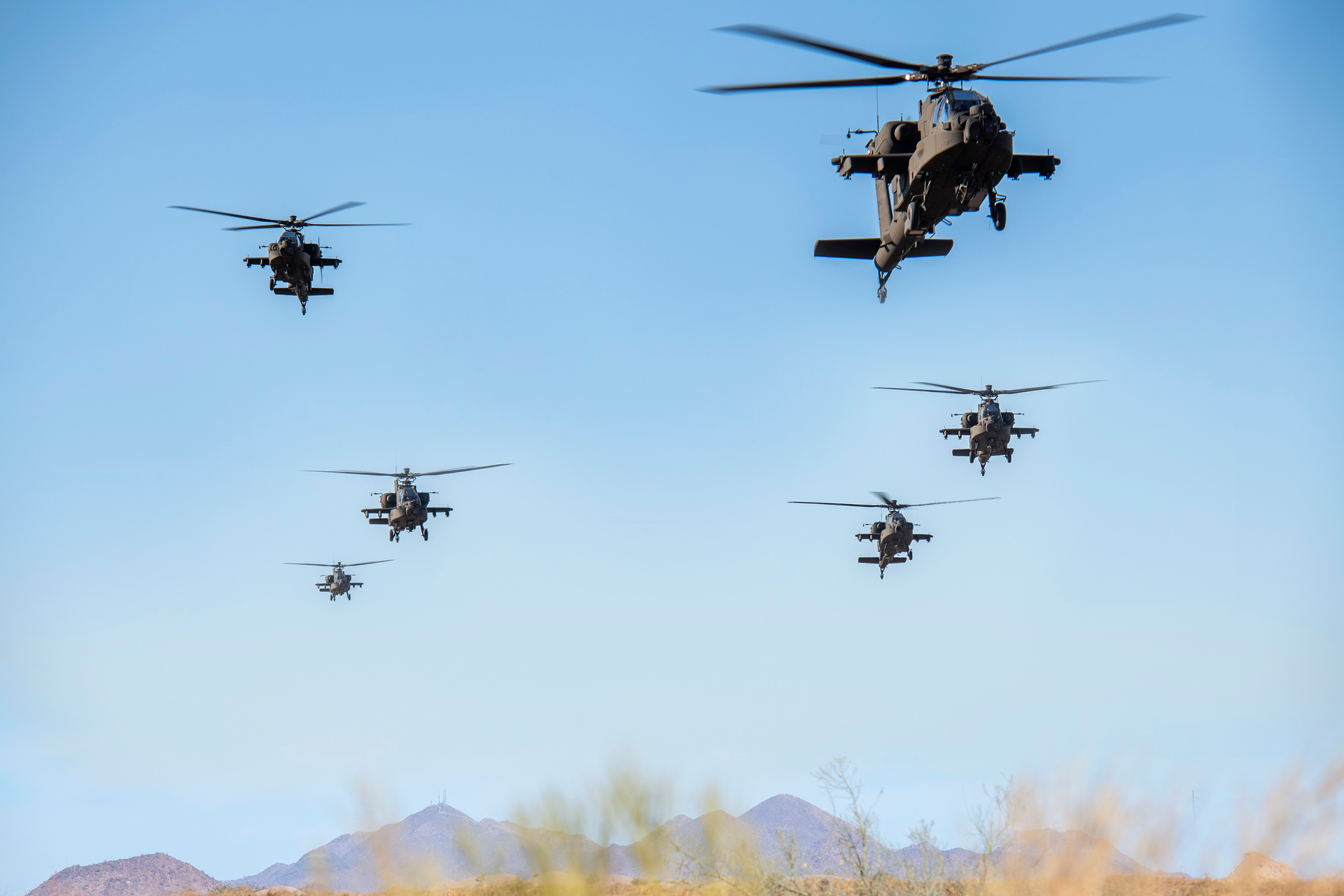 AH-64 Apaches perform a flyover at the Boeing Mesa site in Arizona.