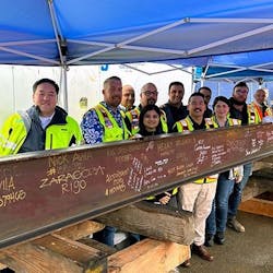 Representatives from Los Angeles World Airports, Austin Commercial, LP, and the project team celebrate the signing of the Tom Bradley International Terminal Core topping out beam.
