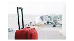 Red Suitcase At Airport 900x600