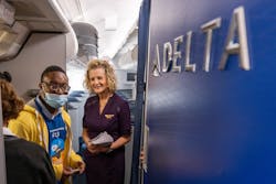 Participants walk onto a Delta Airlines jet during A Wings For All event at the Hartsfield-Jackson Atlanta International Airport Thursday, Apr. 11, 2023