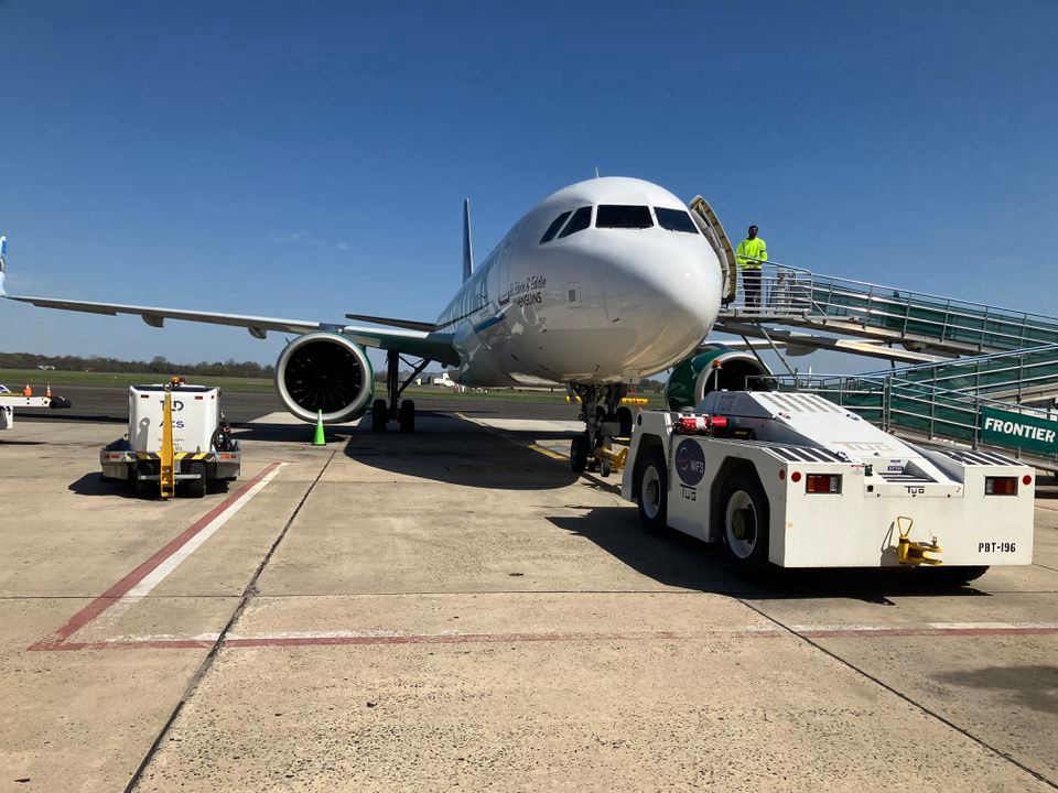 A Frontier Airlines jet waits a Trenton-Mercer Airport for passenger to board who have to use the ramp on the right side of the airport. The current 60-year old terminal can only serve two legae jets similar to this one at a time. U.S. Transportation Secretary Pete Buttigieg toured the airport on Wednesday.