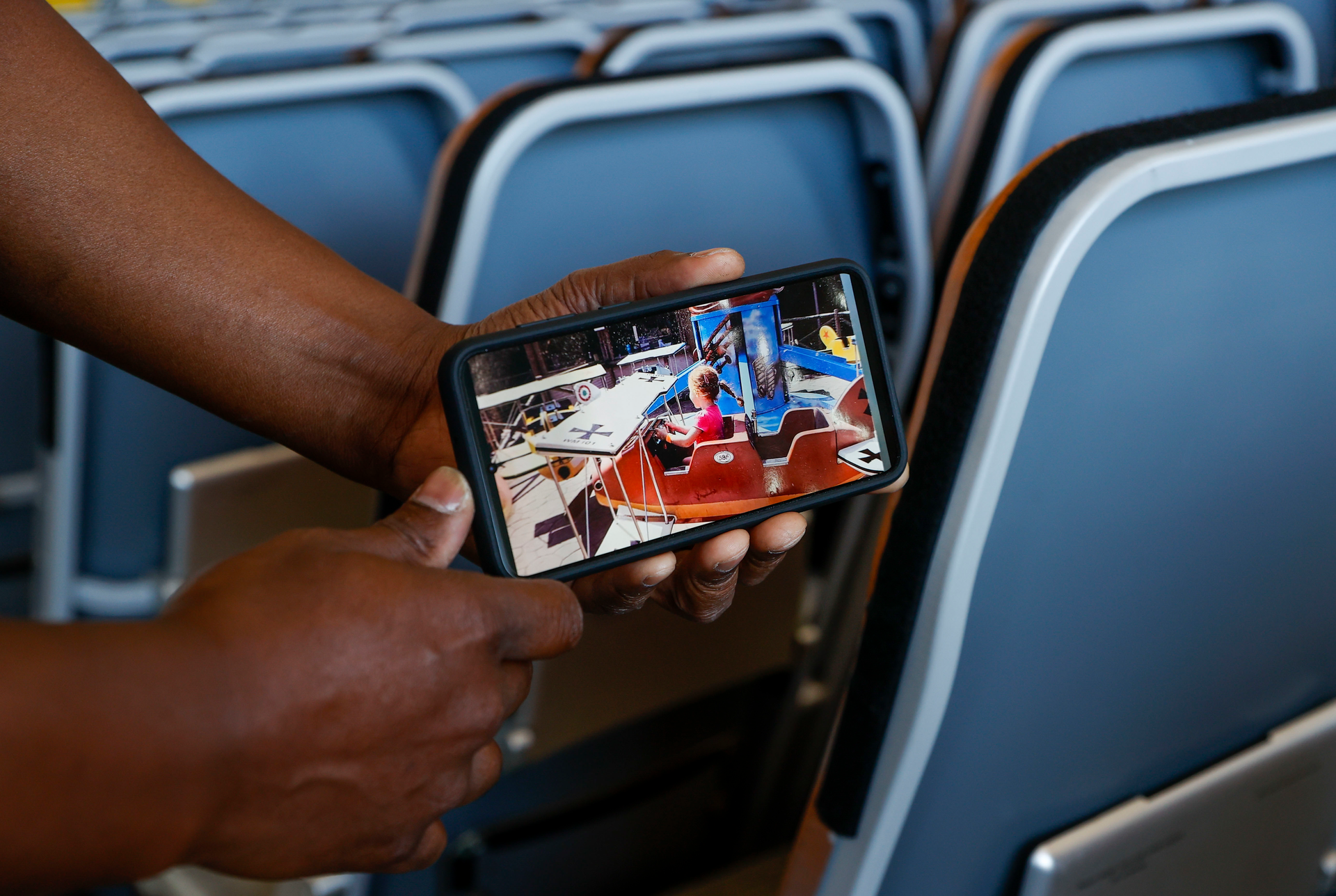 Shaun Brown, who works as an interior mechanic, shows a picture of a photograph he found at Tampa International Airport&rsquo;s Airborne Maintenance and Engineering Services North Hangar on Tuesday.