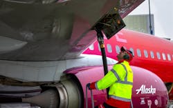 Fueling agent Amer Halilovic keeps his eyes on gauges as he refuels an Alaska Airlines jet at Sea-Tac Airport.
