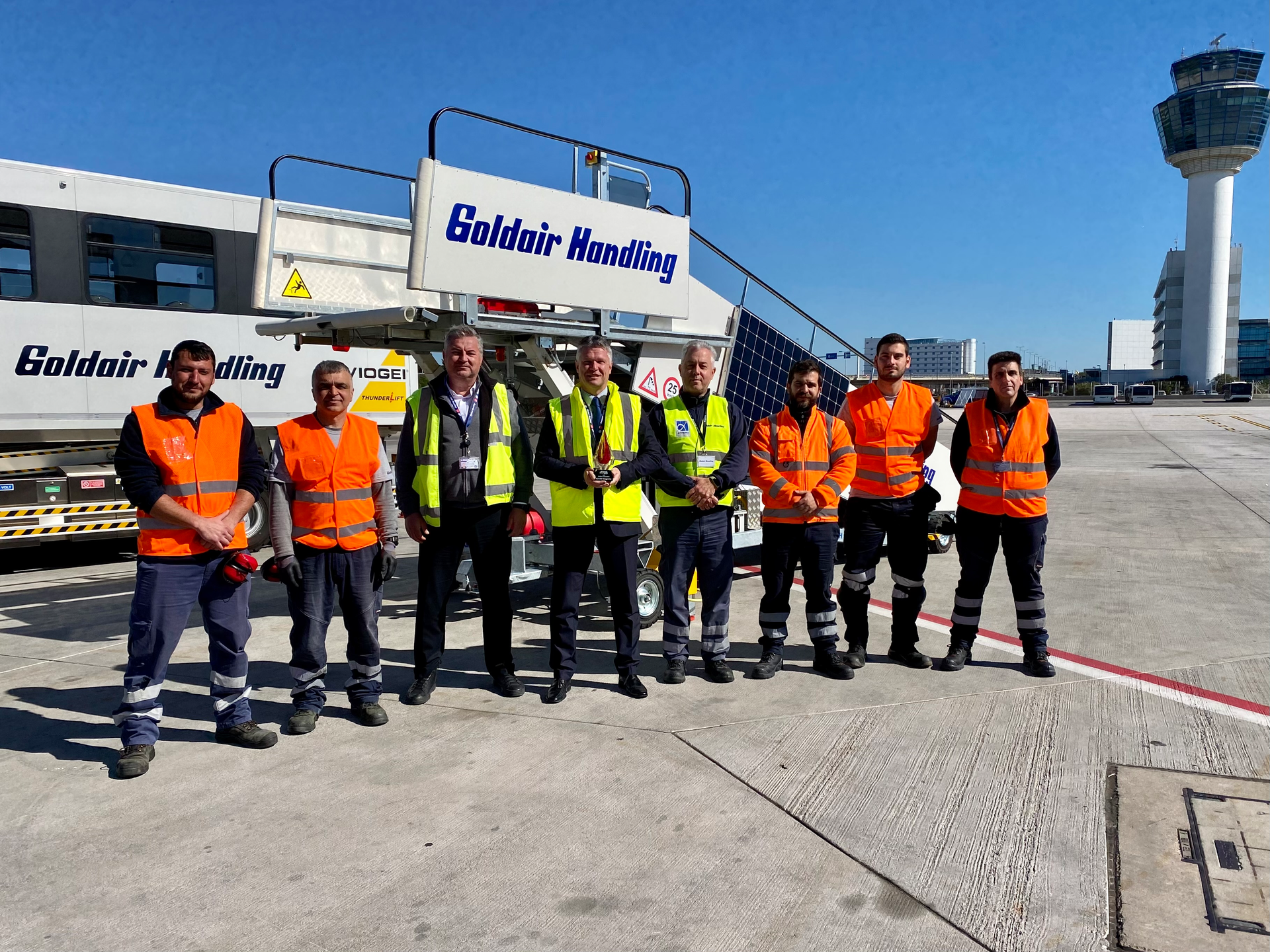 Michalis Panagoulias (center) began as a delivery boy at Goldair Handling before earning several promotions, including his current position as corporate health and safety manager.