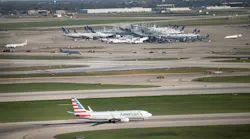 An American Airlines jet taxis below O'Hare's new Satellite South air traffic control tower on Oct. 14, 2015, in Chicago, Illinois. The 209-foot tower will manage air traffic for O'Hare's new 10R/28L runway.