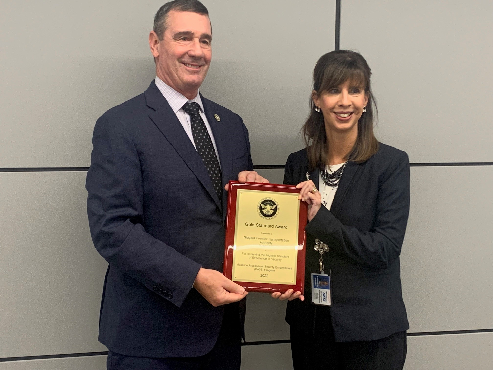 TSA Administrator David Pekoske presents a plaque to NFTA Executive Director Kim Minkel indicating that NFTA received the Gold Standard Award.